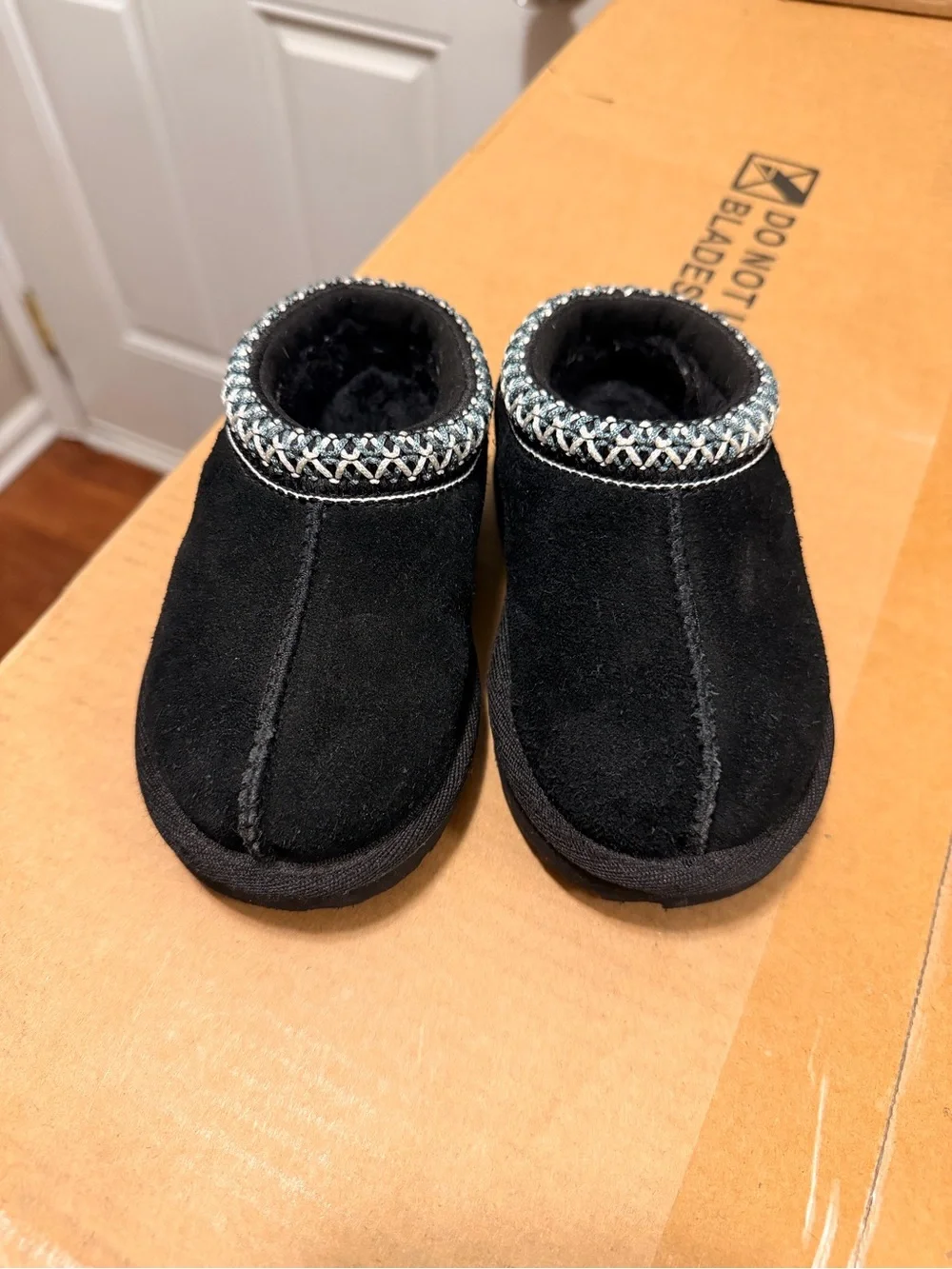 UGG Toddlers Black Suede Slip-On Slippers with Woven Collar